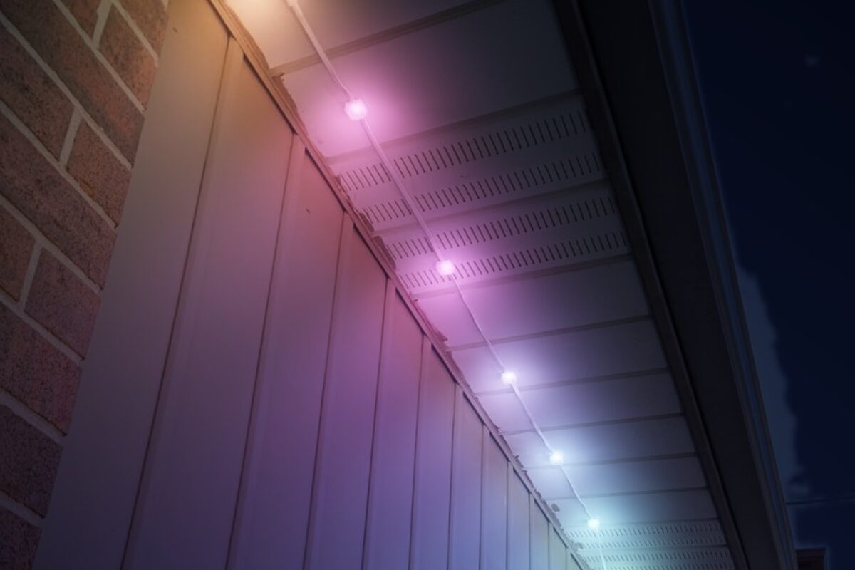 Permanent light pucks installed under the soffit, shown in colour at night