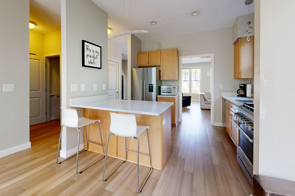 Open kitchen and hallway lit by LED pot lights